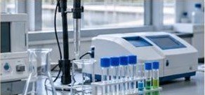 Water testing laboratory bench with spectrophotometer, sample vials and pH probe